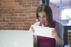 woman with angry expression working at computer